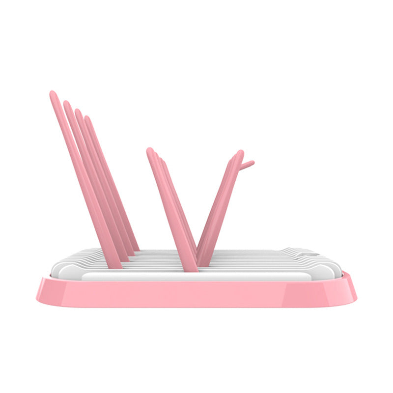 Pink dish drying rack on a white background