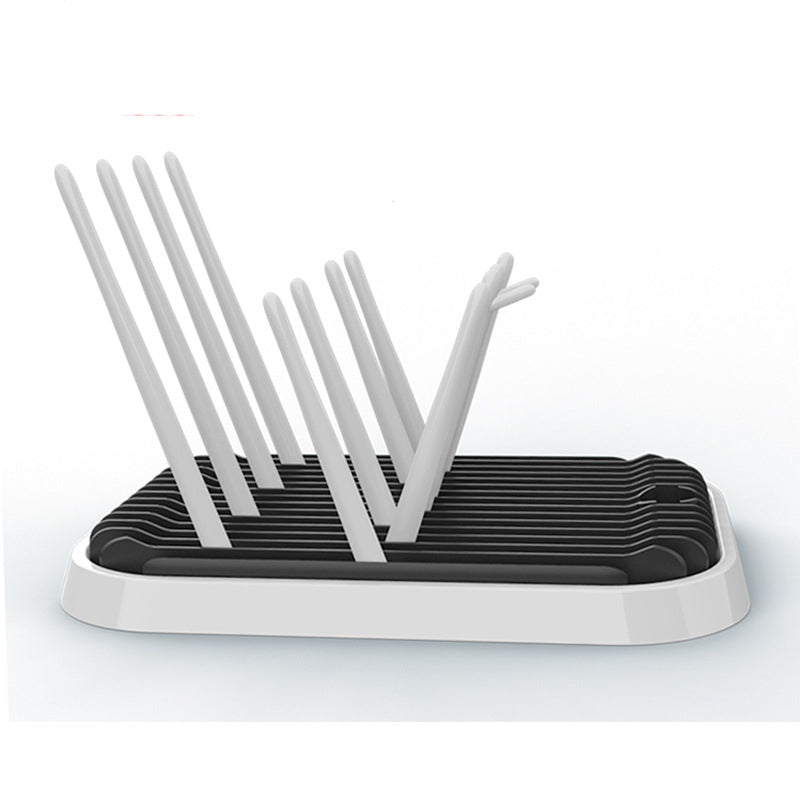 Drying rack with white utensils on a white background