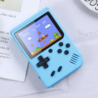 Blue handheld game console with a classic game displayed on the screen, placed on a light surface.