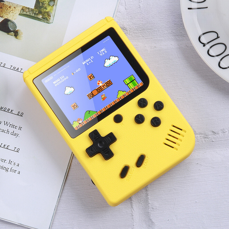 Yellow handheld game console with a classic game displayed on a white surface.