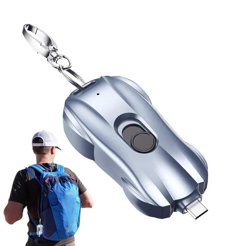Metallic keychain device with USB port on a white background

car shaped phone powerbank with keychain attachment plugging into phone to show charging state 
