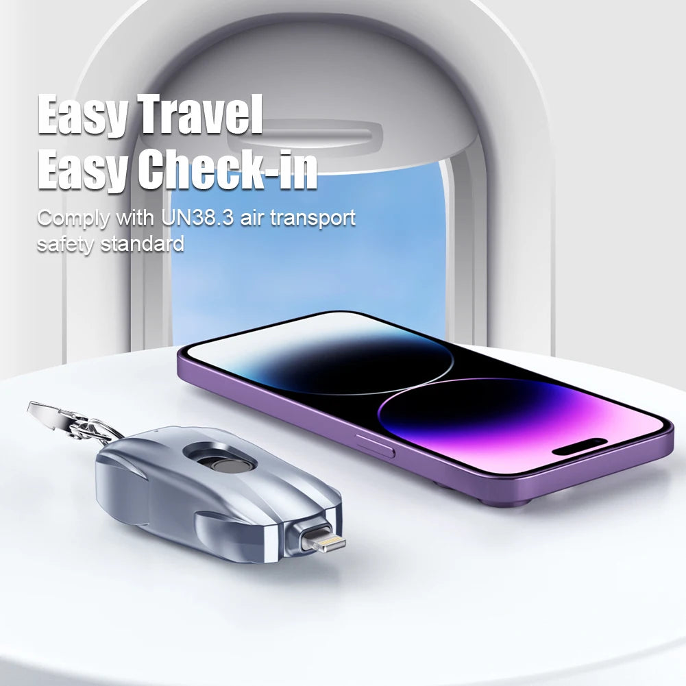 Smartphone with a keychain device on a white surface with a blurred background